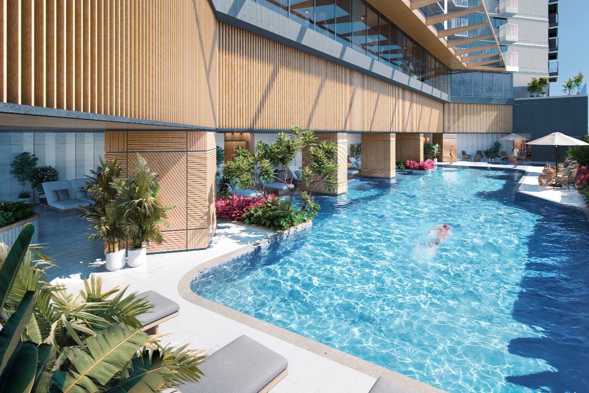 Resort-style condominium pool with landscaped lounge areas and modern amenities