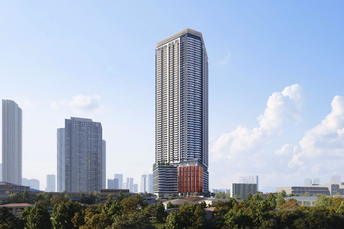 Laya high-rise condominium surrounded by nearby city buildings and greenery under a bright sky