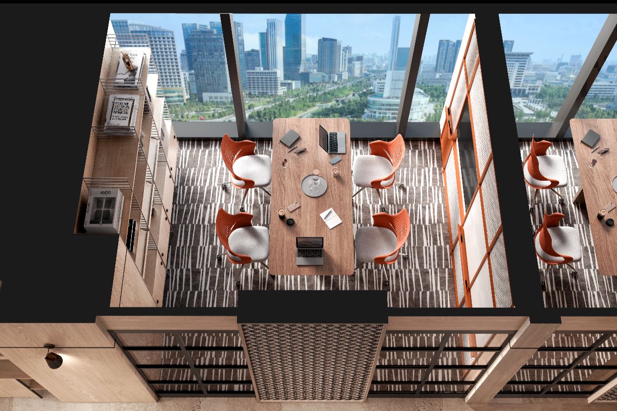 Modern coworking space with city views, long work tables, and orange chairs inside a residential development