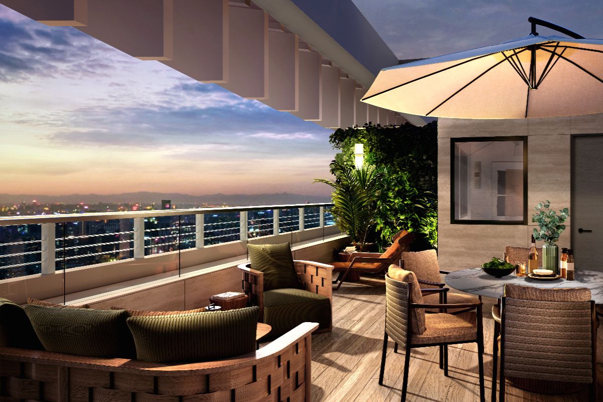 Outdoor residential terrace with city views, lounge seating, dining area, and warm evening lighting