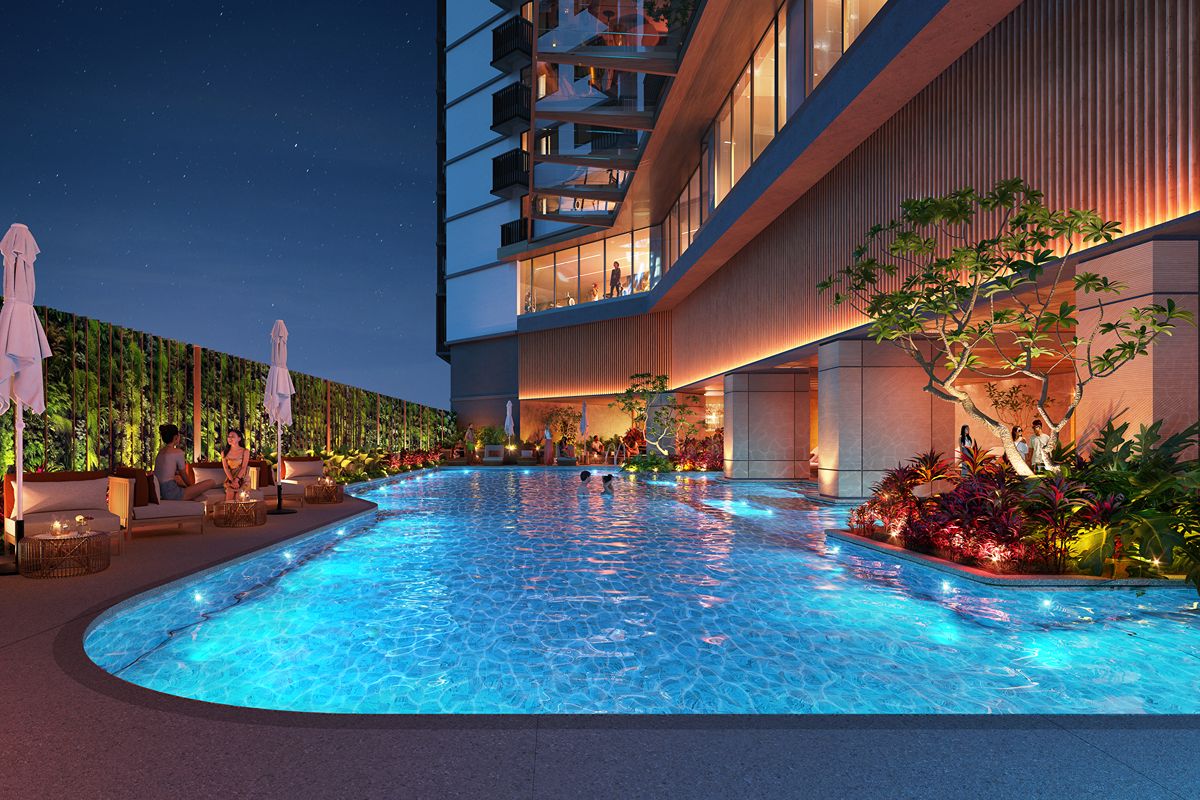 Resort-style outdoor swimming pool at Laya by Shang with landscaped greenery and illuminated residential surroundings
